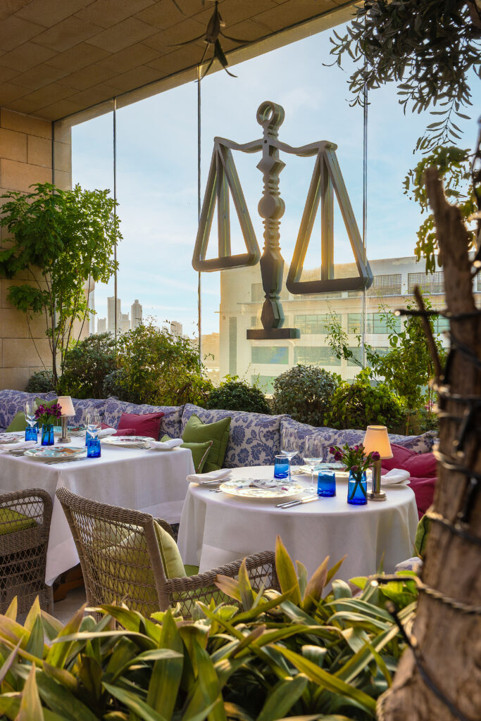 rooftop-manama-sunset.jpg Indigo Terrace, the rooftop restaurant at The Merchant House, at sunset with the Manama skyline behind the brass merchant's scales